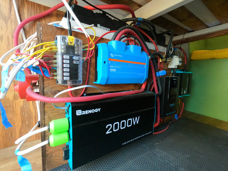 RV rental electrical system: Renogy 2000W inverter, Victron Lynx distributor, Renogy charge controller, and fuse box setup.