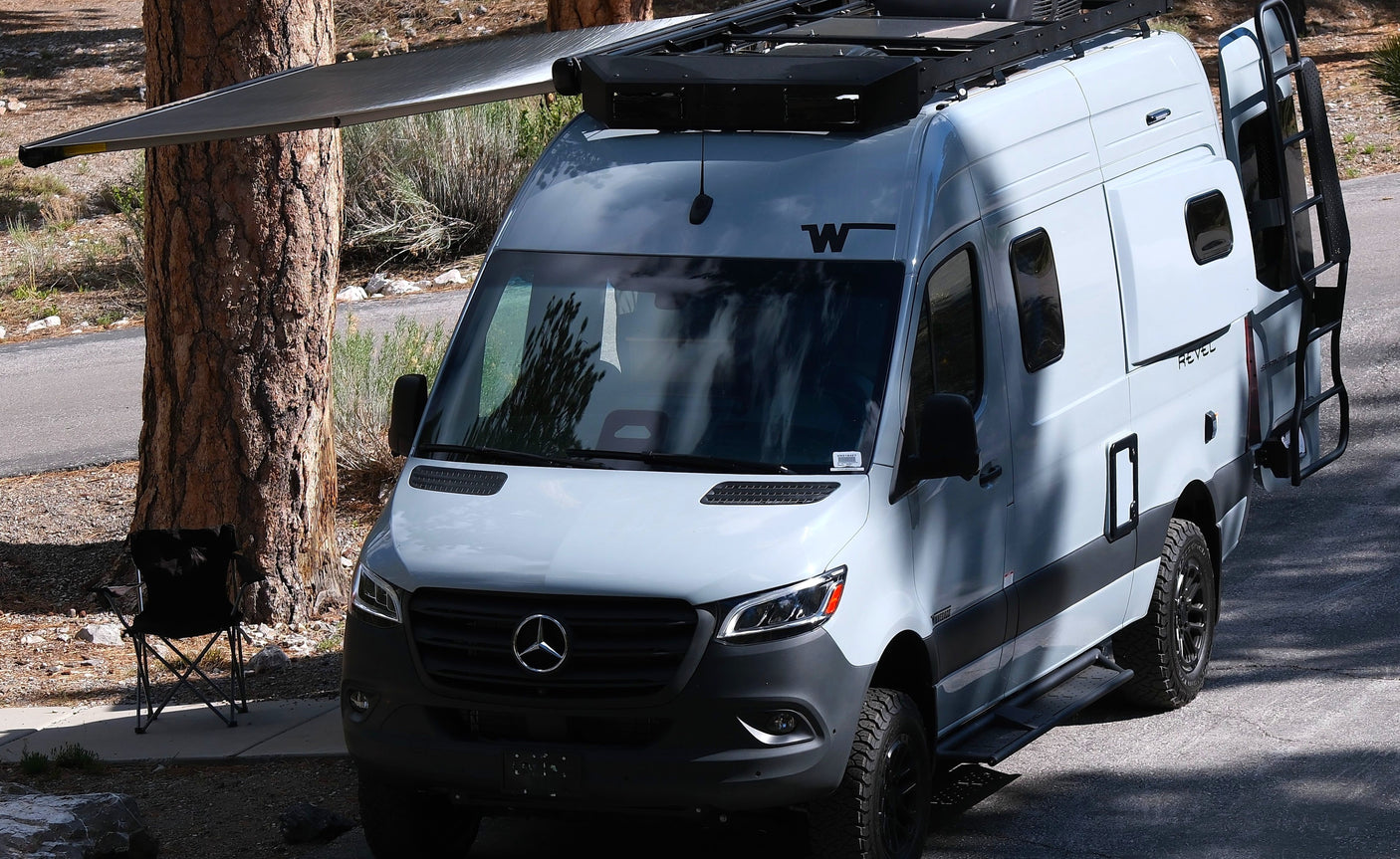 This Winnebago Revel camper van, with its awning extended, offers an ideal rv rental for outdoor adventures and camping.