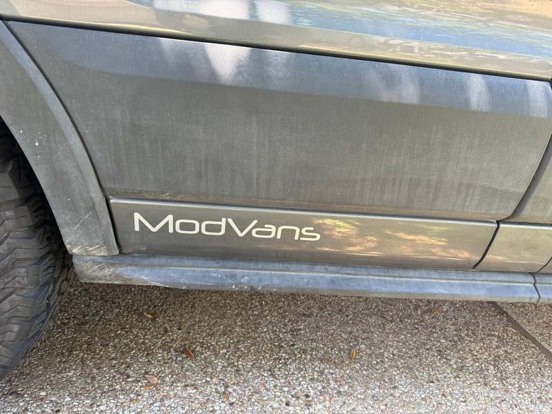  parked on asphalt under a clear sky. Available for rv rental.|A gray ModVans Ford Transit camper van — photo 11