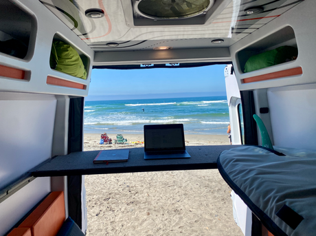 Enjoy remote work from your rv rental! This campervan offers beachfront ocean views, a laptop desk, and space for surfboards.