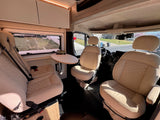 Step inside this inviting rv rental! Features comfortable swivel seats, a small dining table, and modern amenities in a clean camper van.