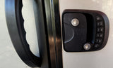 RV rental door with black handle & RVLOCK keyless keypad for secure entry. Two keyholes visible.