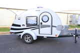 This compact white teardrop RV, featuring stylish black stripes, is perfect for your next rv rental adventure. Ready to hit the road!