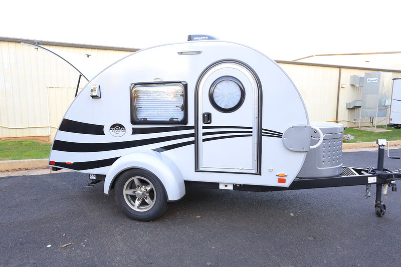 This compact white teardrop RV, featuring stylish black stripes, is perfect for your next rv rental adventure. Ready to hit the road! — photo 6