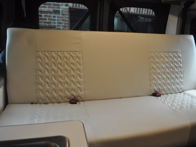  parked under a carport with lush greenery.|Gray Winnebago Solis RV rental parked under a dark carport — photo 5