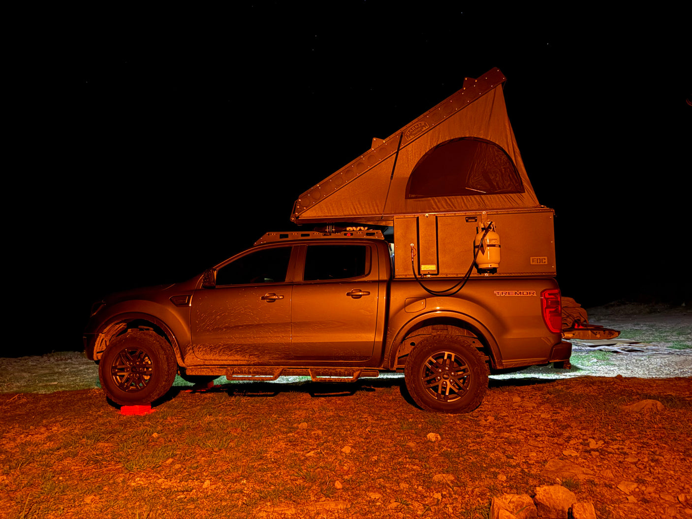 This rugged Ford Ranger Tremor RV rental, equipped with an overland rooftop tent, is set for a night of stargazing camping.