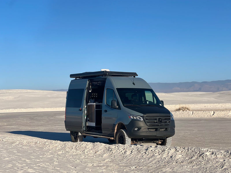  ideal for an rv rental adventure. Sun glints on the waves.|Cozy RV rental interior shows a compact bed — photo 5