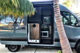Blue-grey camper van rv rental with open side door, revealing its compact, functional interior. Ready for mobile adventures!