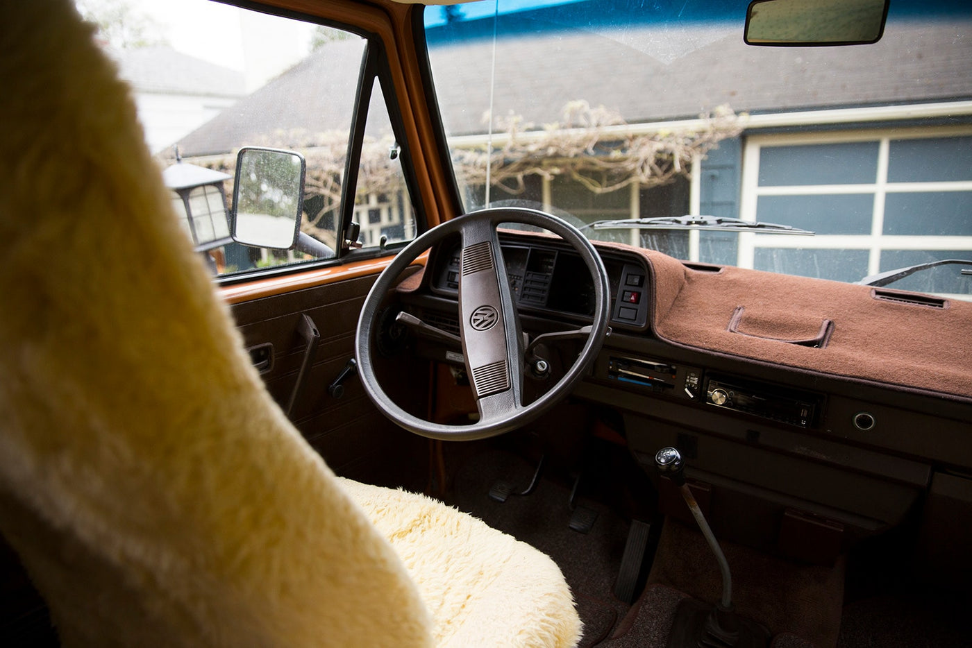 Interior of a classic VW van, possibly an RV rental, with a fuzzy seat cover, brown dashboard, and steering wheel. — photo 6