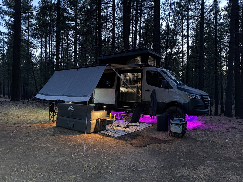  and outdoor chairs & table.|This rv rental features a camper van with an extended awning — photo 14
