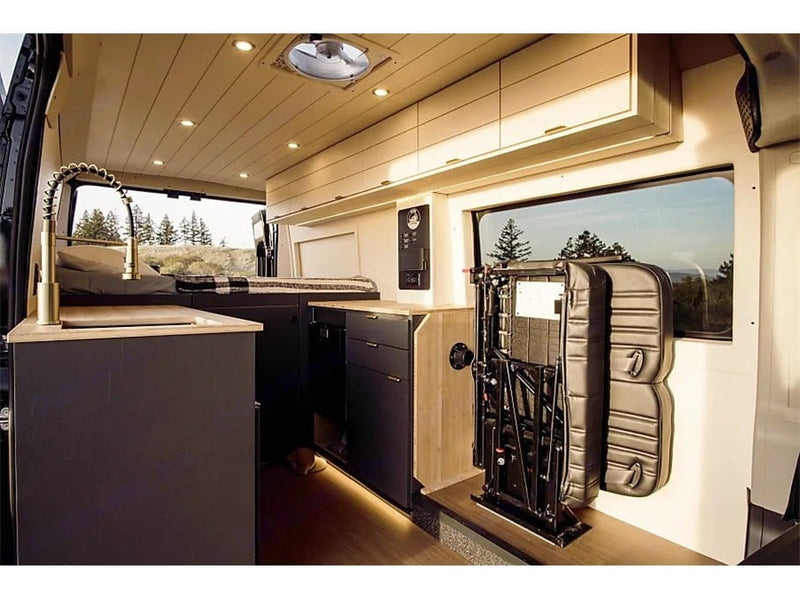  and front cabin seats.|Enjoy a stunning Golden Gate Bridge view from an RV rental rooftop deck overlooking San Francisco Bay at sunset.|RV rental interior: A cozy camper van features a bed — photo 7