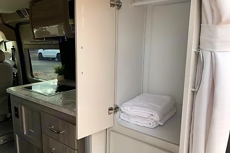  window view of a desert landscape.|RV rental kitchen with stovetop — photo 7