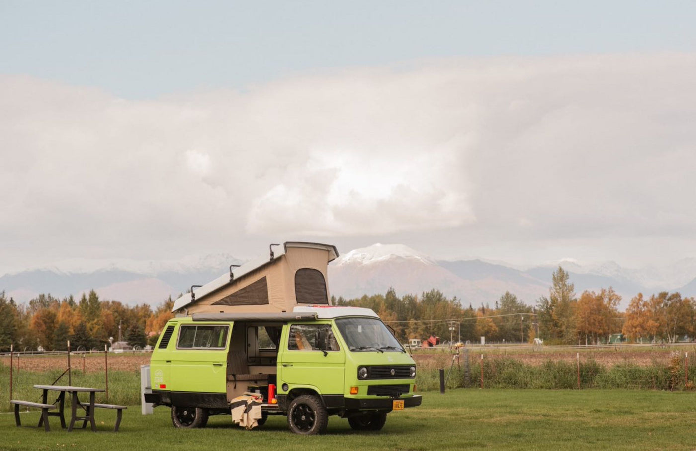  parked in a scenic autumn mountain campsite. Perfect RV rental for adventure.|Lime green VW Vanagon camper. Ideal for RV rental — photo 4