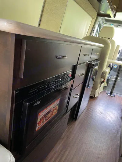  awaits its next road trip indoors.|RV rental camper van floor plan detailing galley kitchen — photo 3