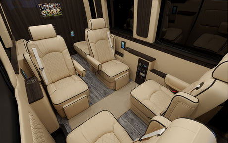 Luxury RV rental interior with plush cream seating, wood accents, and TV. Ideal for comfortable travel.