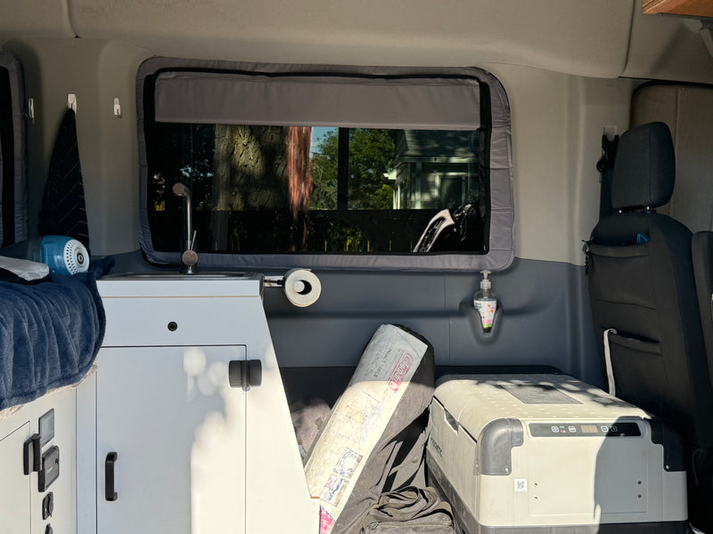 Tour an RV rental's cozy interior: sink, hand soap, Dometic cooler, Coleman table, and window views. — photo 19