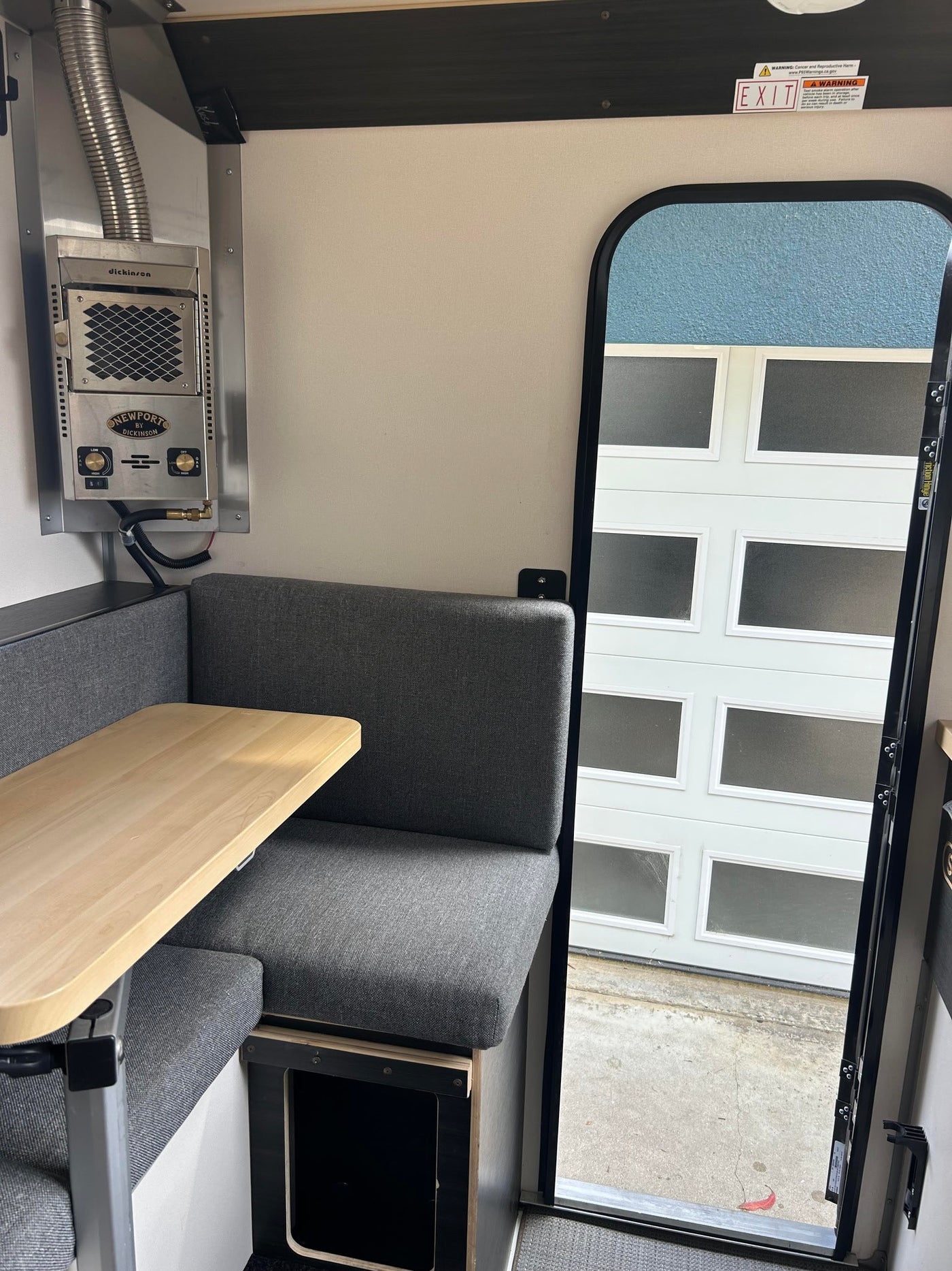  ideal for RV rental adventures. Ready for travel.|Light gray Scout Yoho truck camper on jacks next to a dark pickup truck on concrete. Perfect for RV rental outdoor adventures.|Overhead view of an RV rental's modern interior. Shows a large bed — photo 2