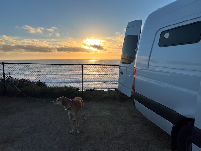  is parked with its side door open at a scenic mountain overlook under a cloudy sky.|Golden hour illuminates an rv rental parked at a scenic overlook — photo 2