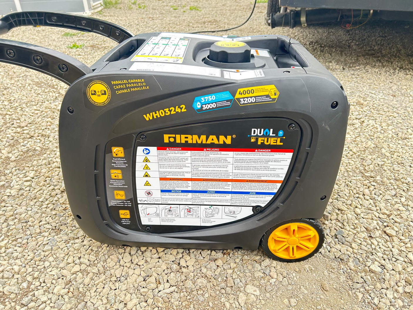 Portable dual-fuel generator on gravel, ideal for rv rental power needs.