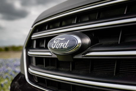 Detailed shot of a Ford vehicle's front grille and oval emblem, suggesting robust options for your next RV rental.
