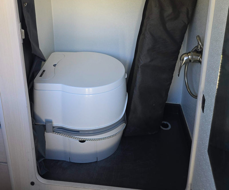  parked with a mountain and bay view.|Scenic rv rental setup: custom camper van with pop-top tent at a lush green campsite with picnic table.|Interior of a custom rv rental camper van — photo 2