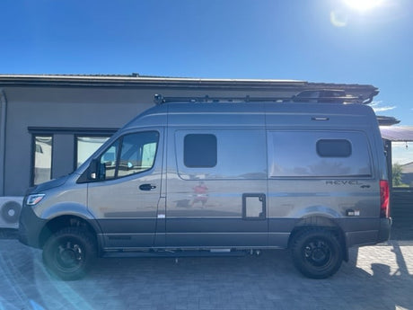 Gray Winnebago Revel 4x4 Sprinter camper van for rv rental, parked on a sunny day. Ideal for outdoor adventures.