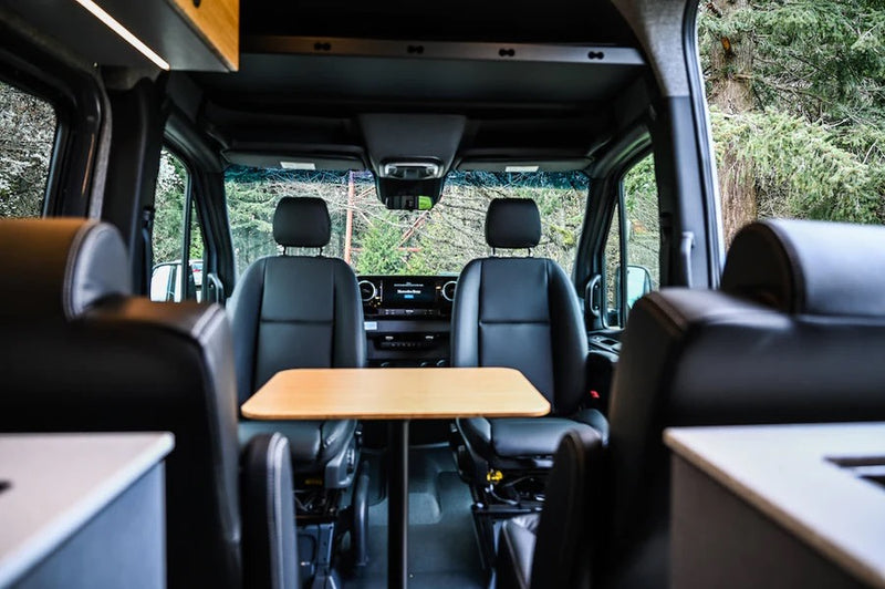  and a scenic window view.|Cozy RV rental interior with a raised bed — photo 2