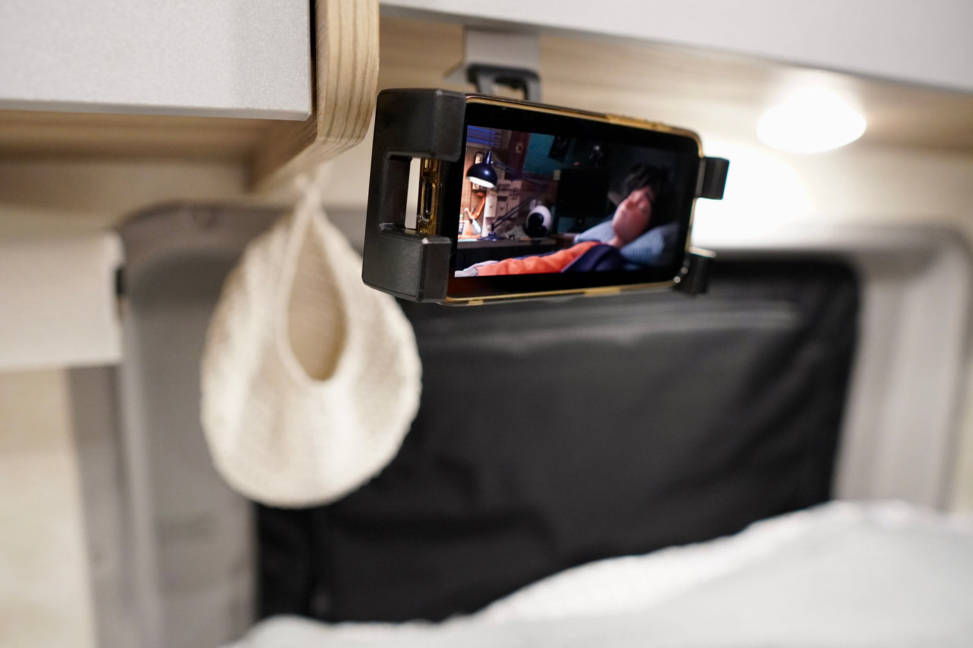 Smartphone mounted for mobile entertainment in an RV rental. Watch movies on the go from your cozy travel interior.