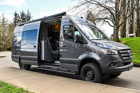 Explore in style with this gray Mercedes-Benz Sprinter conversion camper van, perfect for rv rental. Side door open, revealing interior.