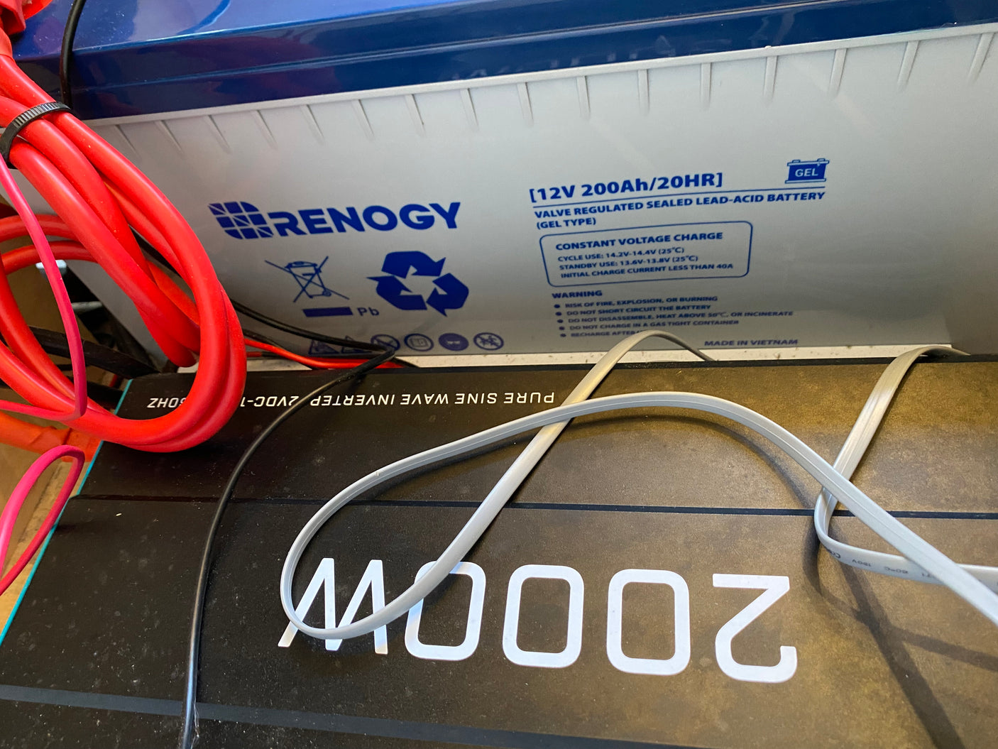 Close-up of a Renogy 12V battery and 2000W inverter, essential components for an rv rental power system.