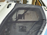 RV rental featuring a black mesh mosquito screen over an RV door or window for bug-free travel.