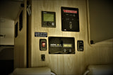 RV rental's control panel displays solar charge, water pump, tank levels, and climate settings.