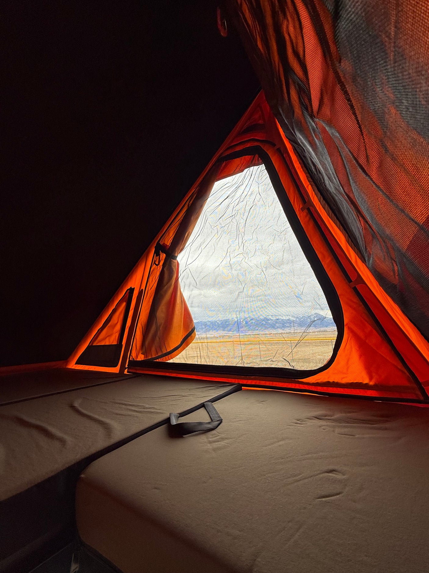 Wake up to nature! Cozy rv rental rooftop tent with a scenic mountain view, ideal for outdoor adventures.