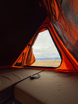 Wake up to nature! Cozy rv rental rooftop tent with a scenic mountain view, ideal for outdoor adventures.