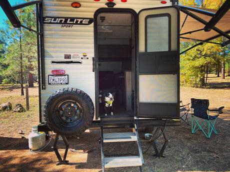 A cozy Sun Lite Sport 16BH **rv rental**, perfect for pet-friendly camping adventures, with a Boston Terrier on guard.