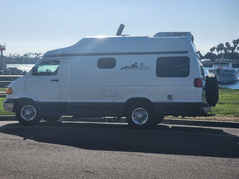 White RV rental parked seaside on a sunny day. Palm trees — photo 1