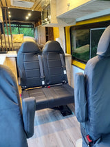 Well-appointed RV rental interior featuring comfortable seating, a compact kitchen, and a rear sleeping area.