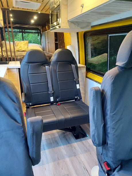 Well-appointed RV rental interior featuring comfortable seating, a compact kitchen, and a rear sleeping area.