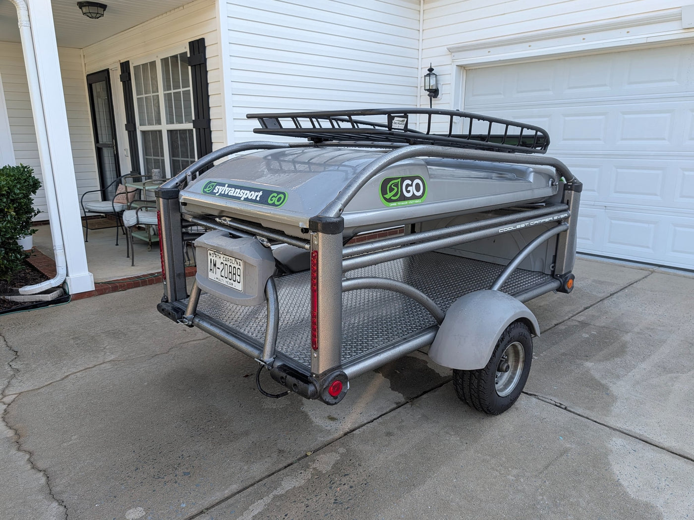  is parked in a driveway. Consider it for your next RV rental.|This SylvanSport Go pop-up camper — photo 3