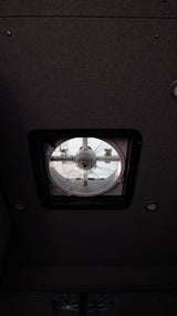 Inside an rv rental: View of the ceiling with a roof vent fan and recessed lighting.