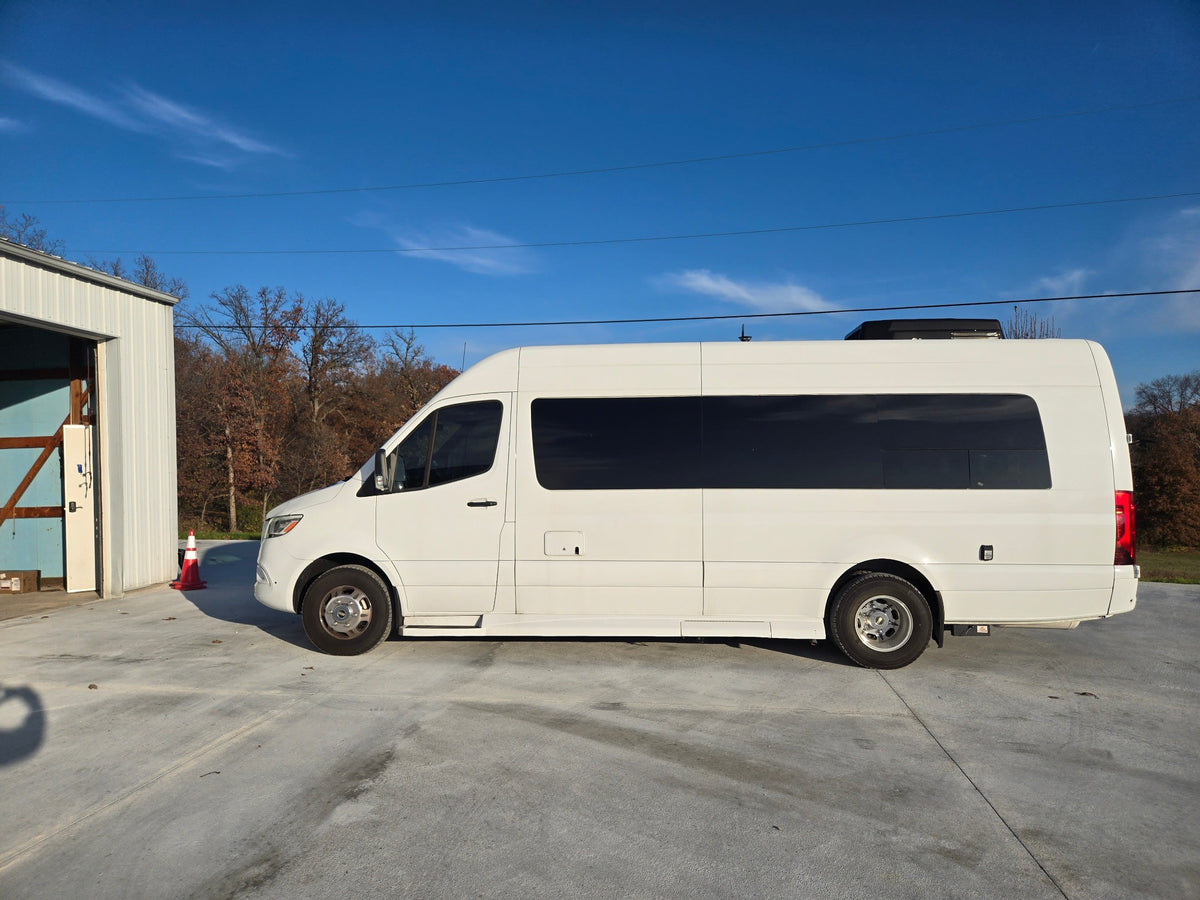 presented in a showroom featuring "THE GATEWAY" illuminated sign.|White Sprinter conversion van