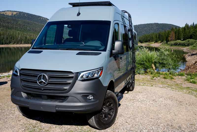  cloudy sky.|Gray Mercedes-Benz Sprinter camper van by a lake with mountains — photo 5