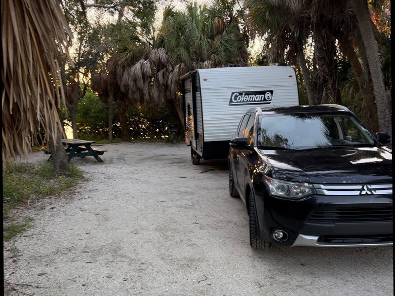  is ready for your next outdoor adventure.|A black SUV tows a Coleman RV rental at a scenic — photo 5