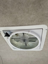 An RV rental features a Maxx-Fan ceiling vent with screen, offering fresh air. Light grey upholstered interior.