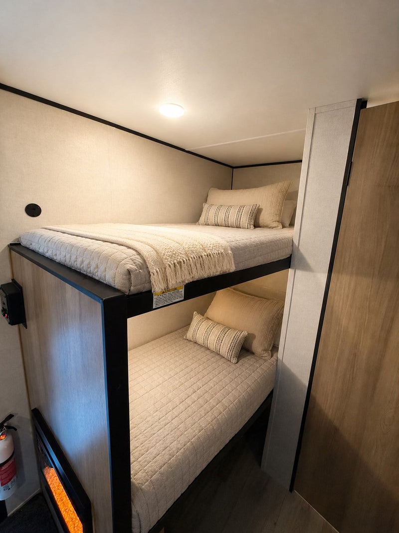  and an 8' awning for travel.|Experience comfort in this modern RV rental interior featuring a bed — photo 12