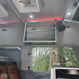 Explore this RV rental's organized interior: overhead storage with bungee cords, bright and ambient lighting for comfortable travel.