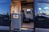 Custom Baller Adventures camper van RV rental interior: featuring a modern shower area, comfortable seating, and wood paneling.