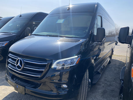 New black Mercedes-Benz Sprinter van, perfect for RV rental or travel, in a bright outdoor lot.
