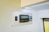 RV rental interior: A control panel features an ON/OFF switch, display tablet, and power monitor for managing onboard systems.