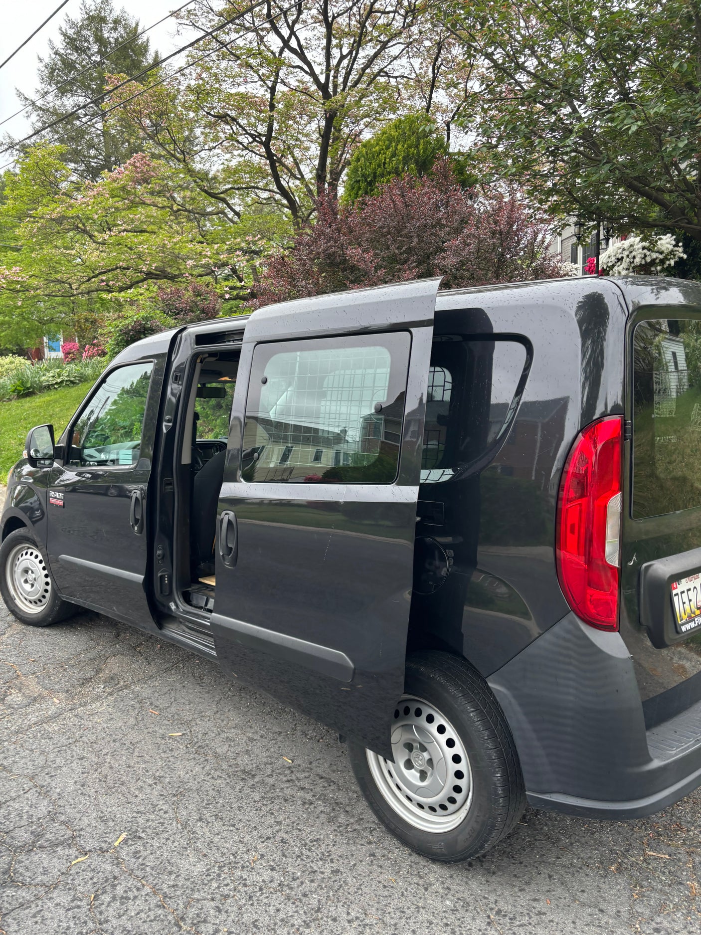 Dark gray Ram ProMaster City van, doors open, ready for your next project. Part of our versatile rv rental options.